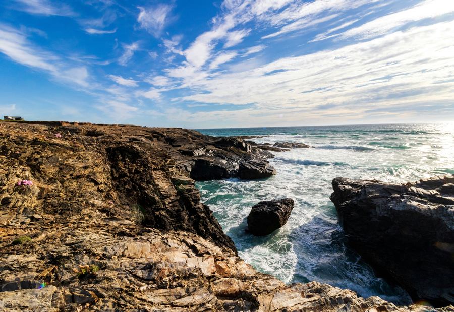 Waves breaking over the rocks below a North Cornwall headland