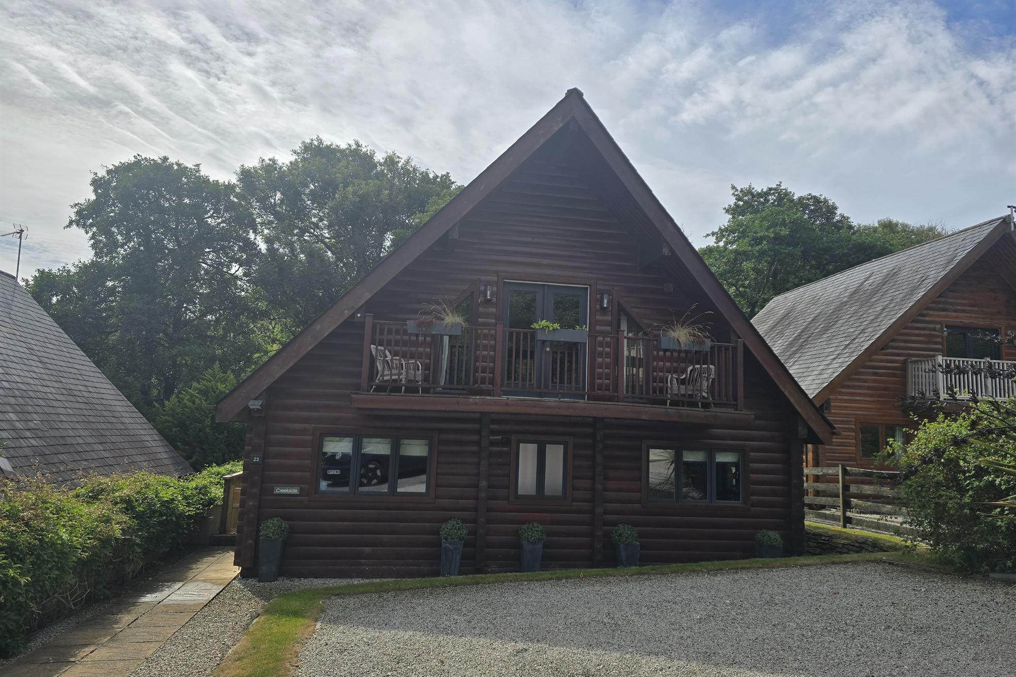 Creekside Retreat, a Canadian-style log house in Little Petherick, seen from the drive