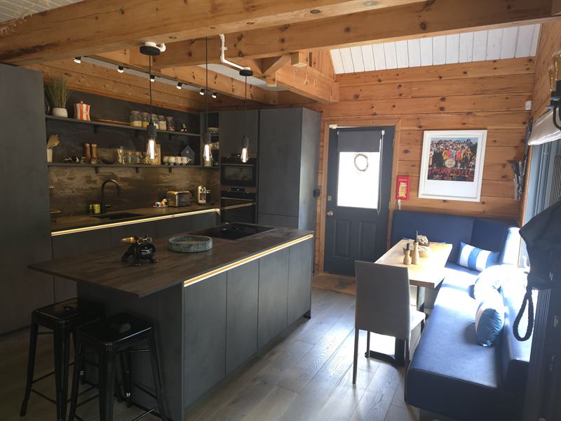 The kitchen, with an island, induction hob and a dining booth